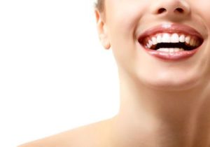 woman showing off her beautiful smile after cosmetic dentistry service